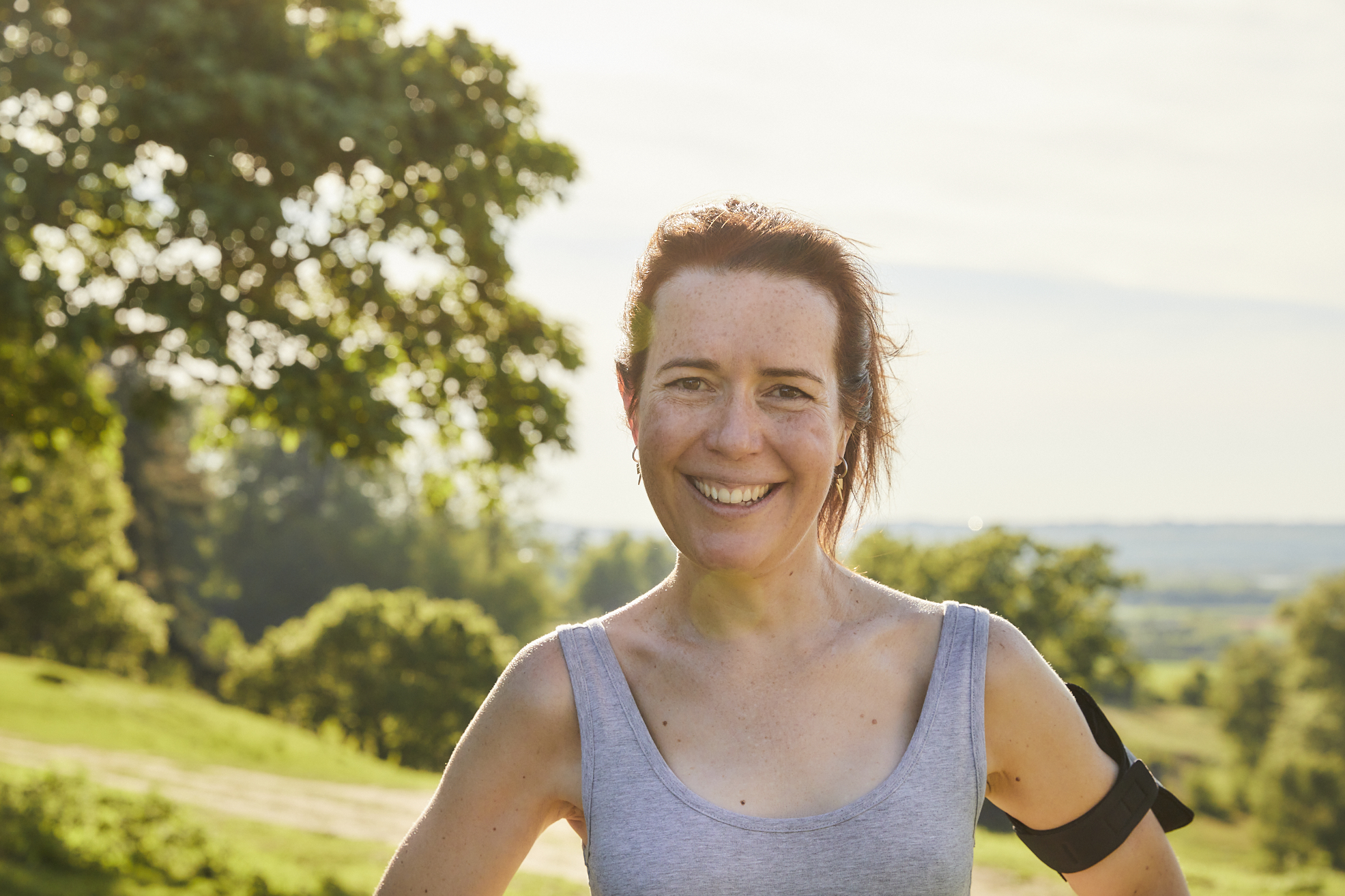 Women in grey running top smiling