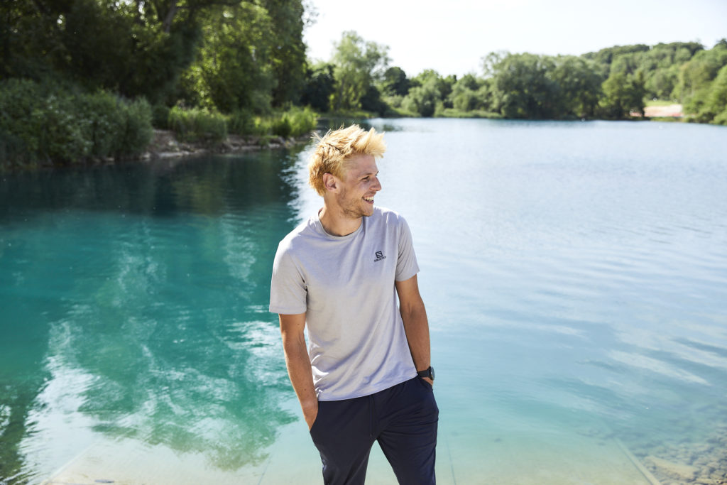 Max in grey t-shirt standing next to a lake